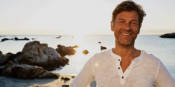 man standing on a rocky beach